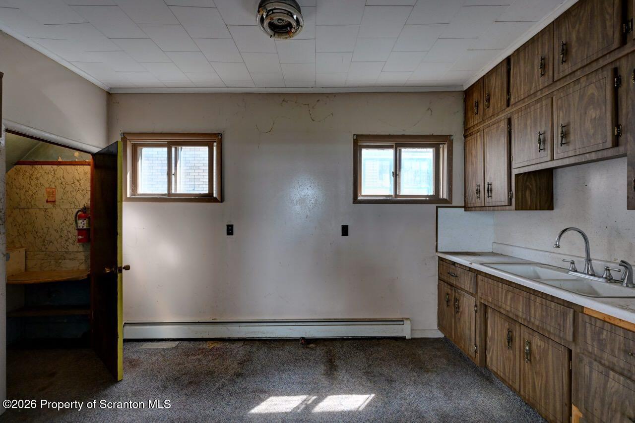 18 Green Ridge Street Scranton, PA 18509 - Photo 15 of 29 a kitchen with sink a refrigerator and cabinets