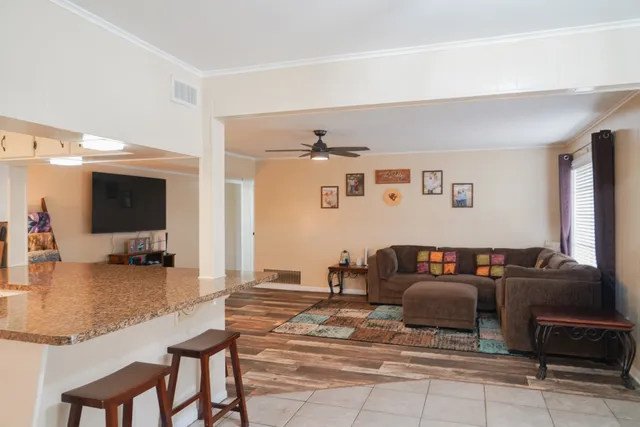 a living room with furniture and a flat screen tv