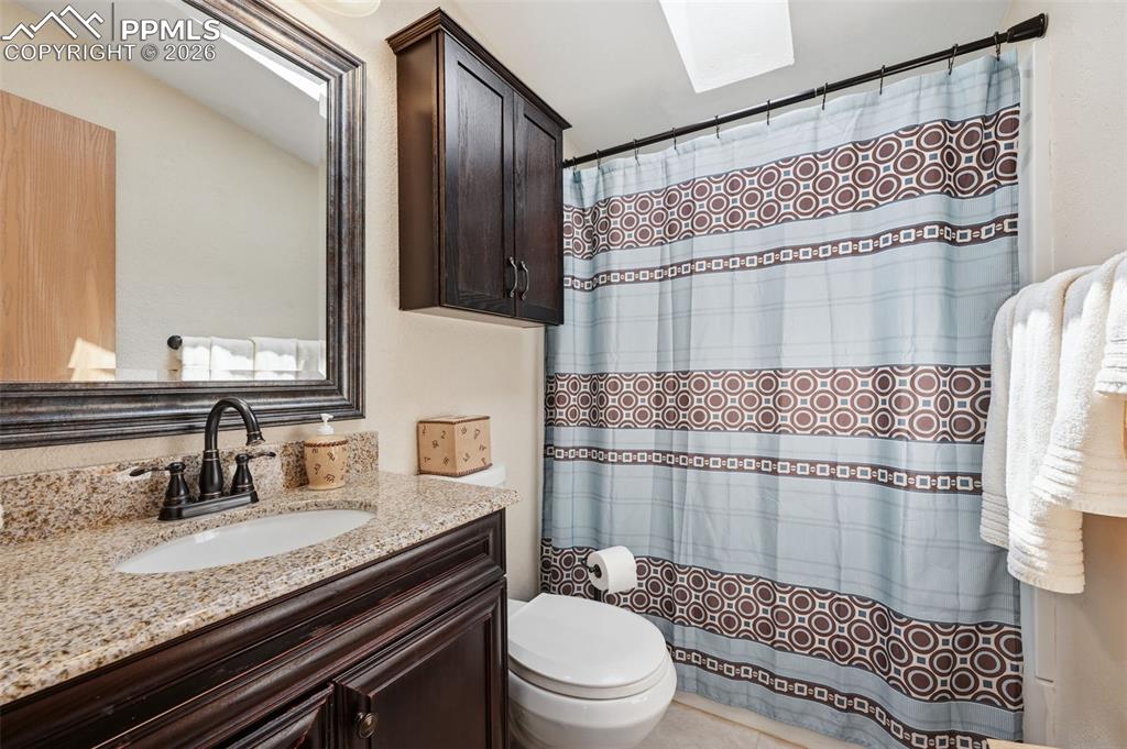 20985 McDaniels Road Calhan, CO 80808 - Photo 39 of 41 a bathroom with a granite countertop sink toilet and shower