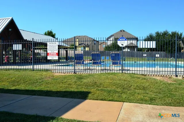 a view of a park with iron fence