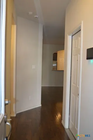 a view of a room with wooden floor