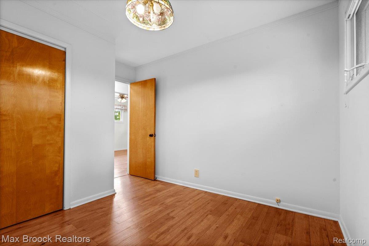 1330 Oak Street Rochester, MI 48307 - Photo 17 of 35 Wood-finish flooring, white walls, and a window providing natural light