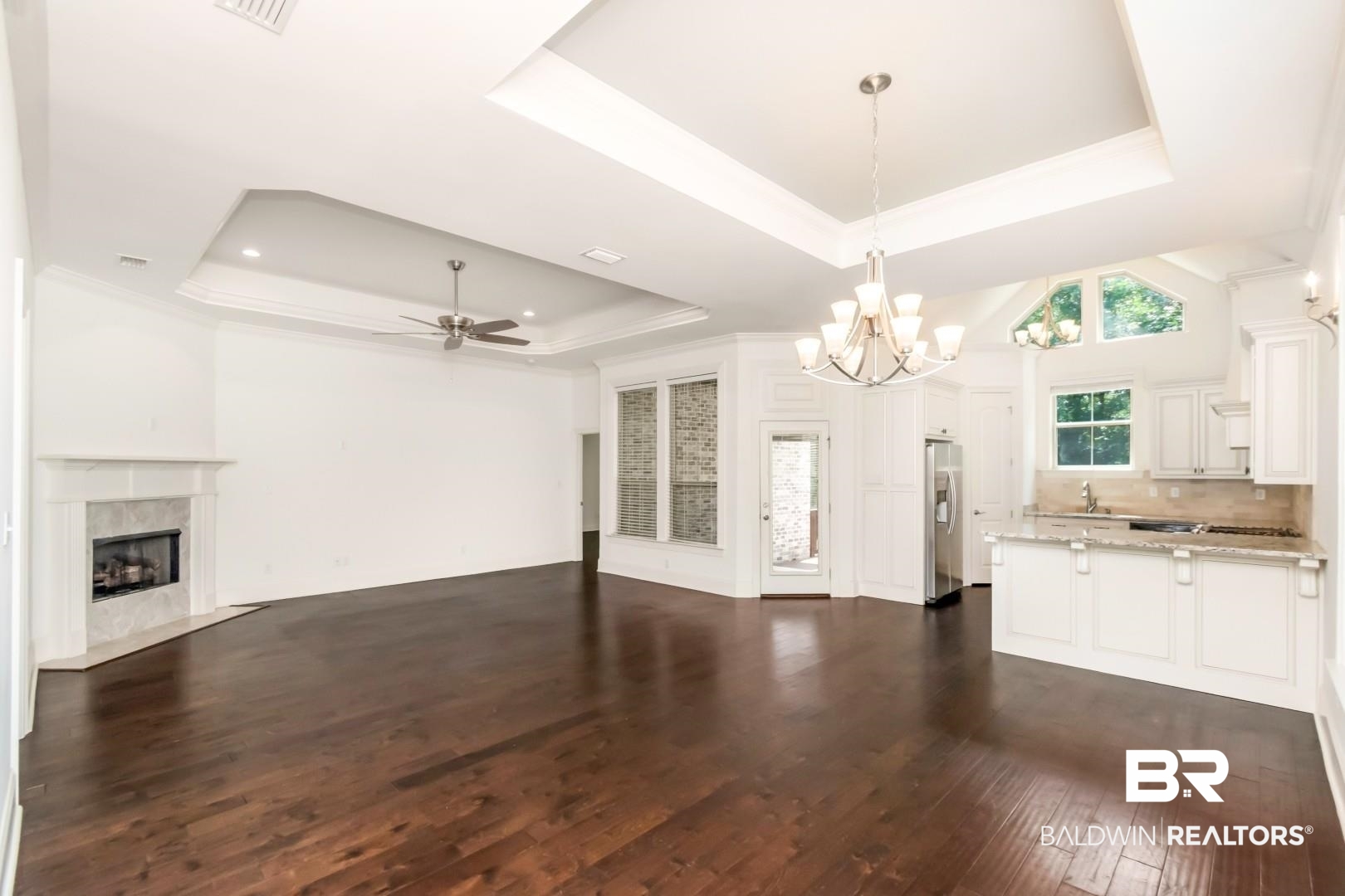 3528 Rue Royal Mobile, AL 36693 - Photo 4 of 53 Expansive room featuring rich wood-finish flooring and a tray ceiling with recessed lighting