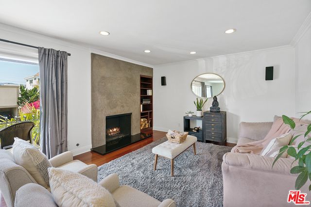 a living room with furniture a fireplace and a potted plant