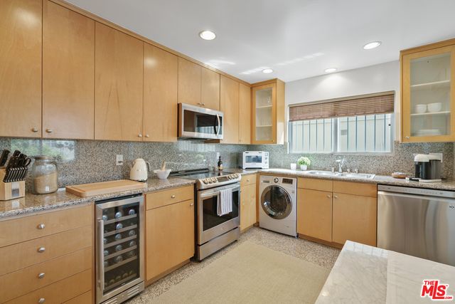 a kitchen with stainless steel appliances granite countertop a stove sink and cabinets