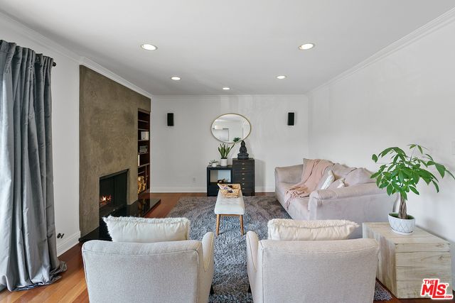 a living room with furniture a fireplace and a potted plant