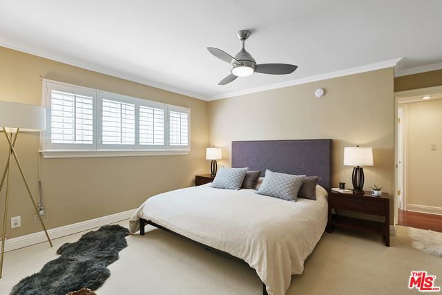 a bedroom with a large bed and a chandelier