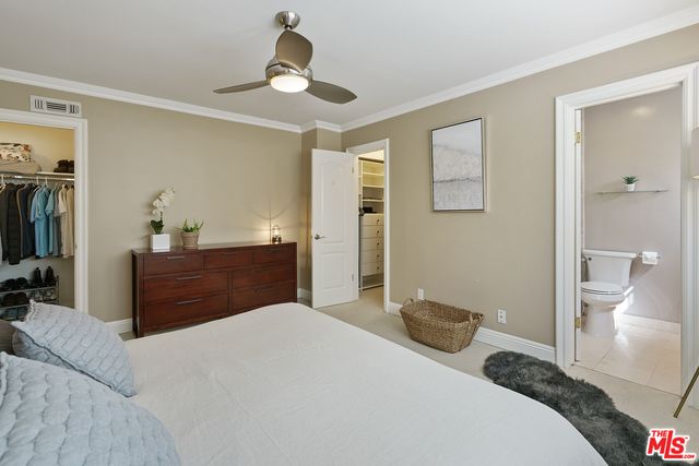 a bathroom with a granite countertop sink a toilet and a mirror