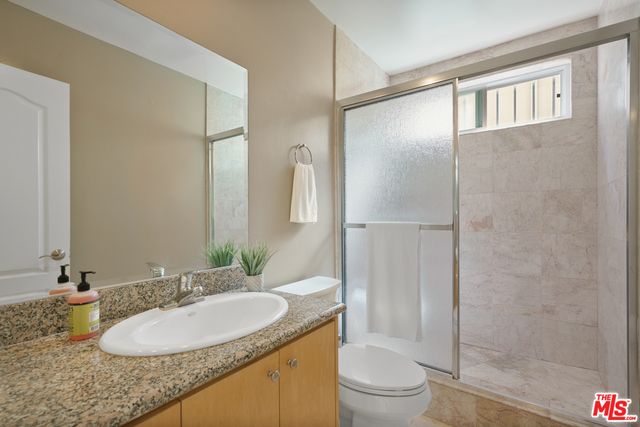 a view of a house with a small yard and potted plants