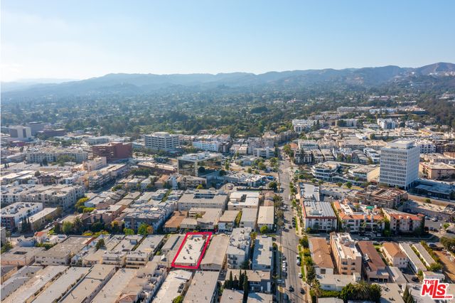 an aerial view of residential houses with city view