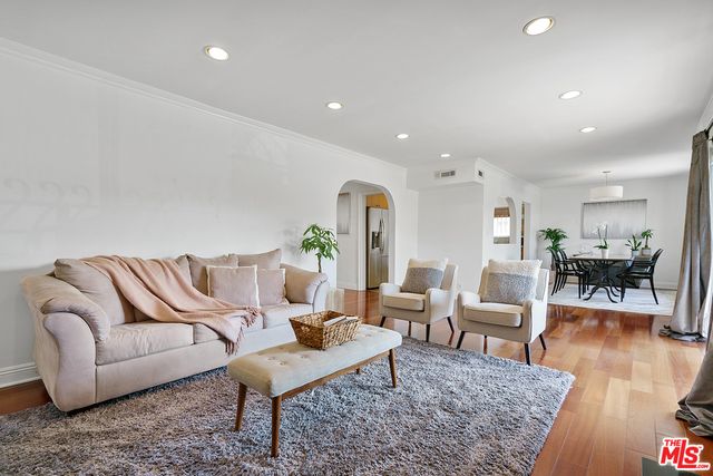 a living room with furniture rug and wooden floor