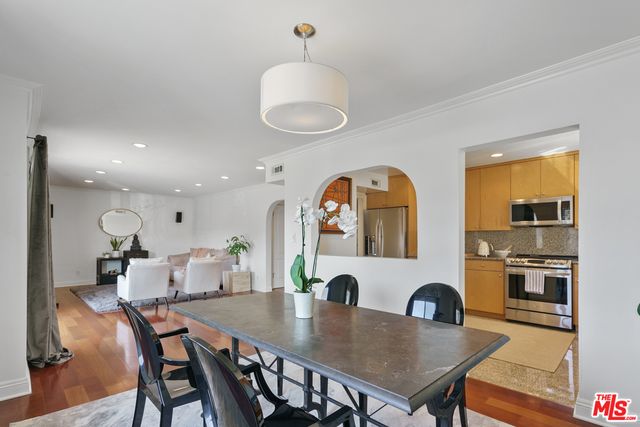 a view of a a dining room with furniture window and wooden floor
