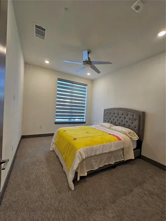 a bed sitting in a bedroom next to a window