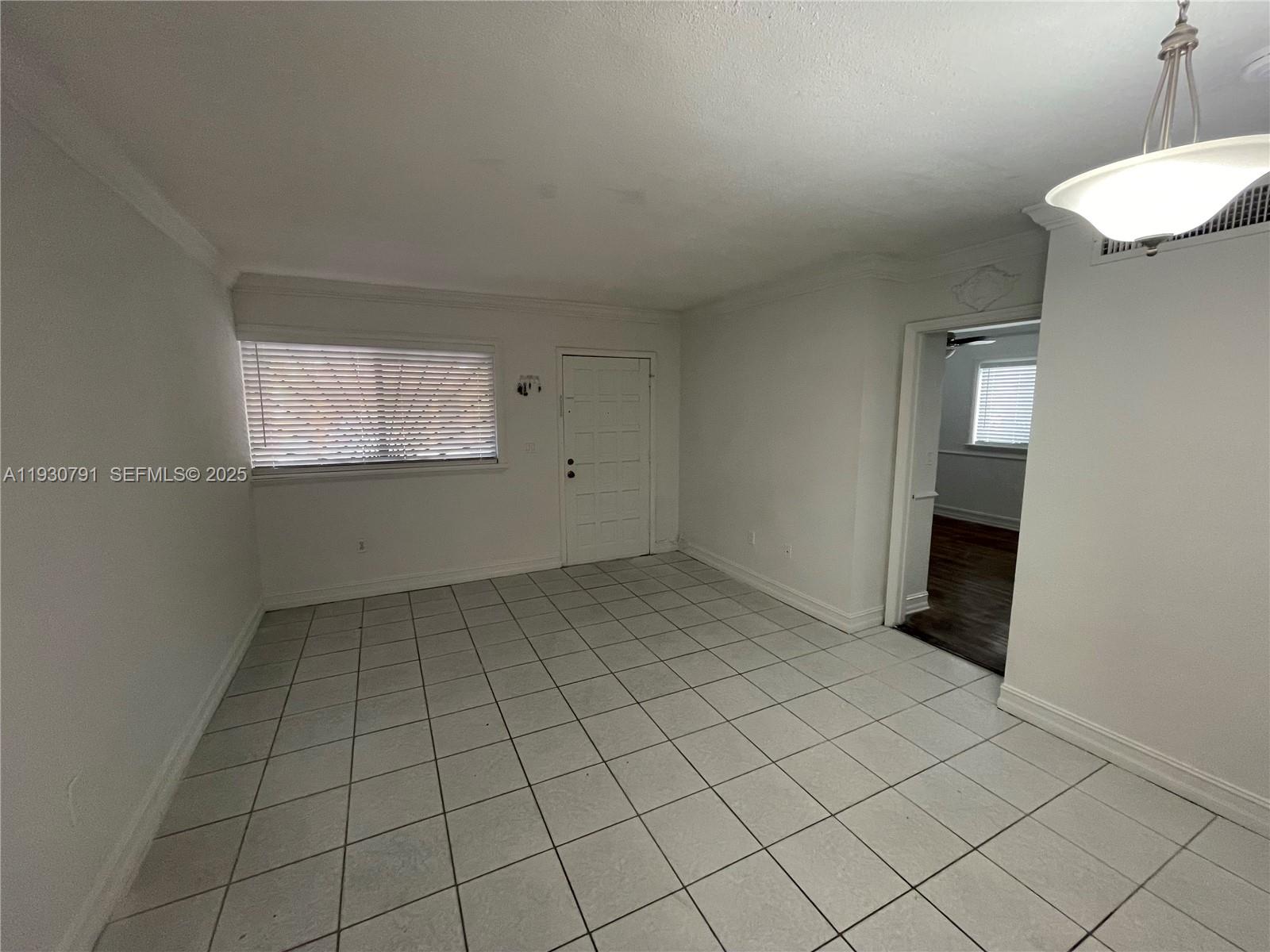 6450 West 27th Way, Unit 101 Hialeah, FL 33016 - Photo 2 of 11 a view of an empty room and window