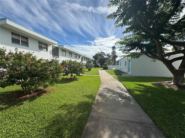 a view of a house with a backyard