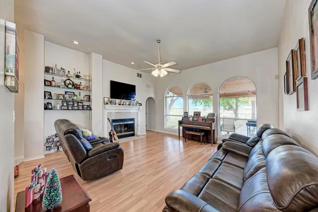 a living room with furniture a fireplace and a flat screen tv