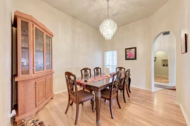 a view of a dining room with furniture wooden floor and chandelier