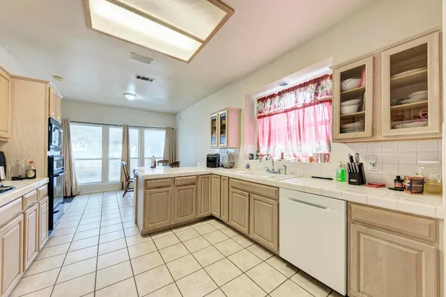a kitchen with a sink and cabinets