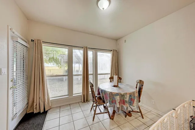 a view of a dining room with furniture and a window