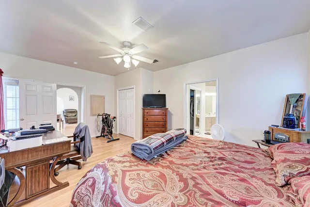 a bedroom with a bed and a chandelier