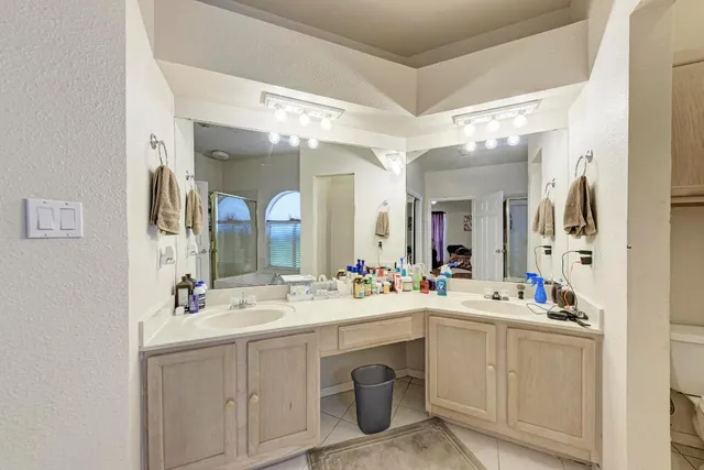 a bathroom with a sink double vanity and a mirror