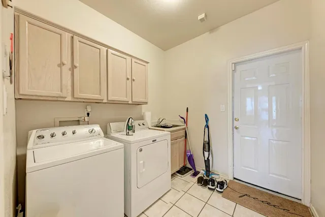 a view of a storage & utility room with dryer and washer