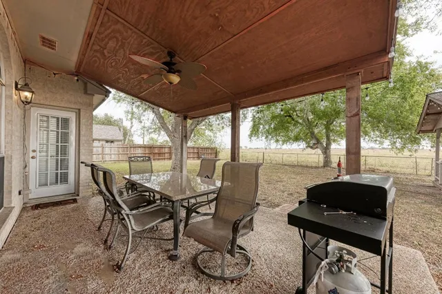 a view of a patio with furniture and wooden floor