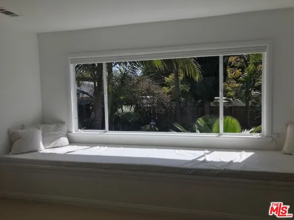 a living room with a large window and front door