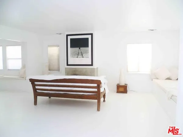 a bedroom with furniture and window