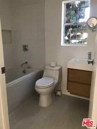 a bathroom with a toilet a sink and bathtub