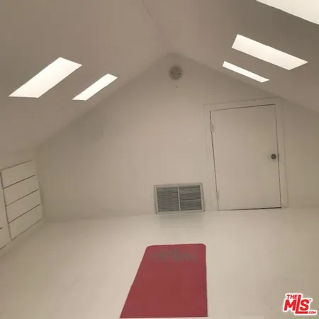 a dining room with furniture and a window