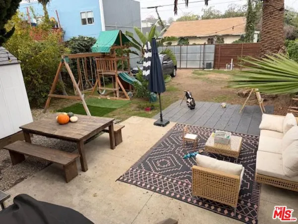 a view of a patio with couches chairs and a potted plant
