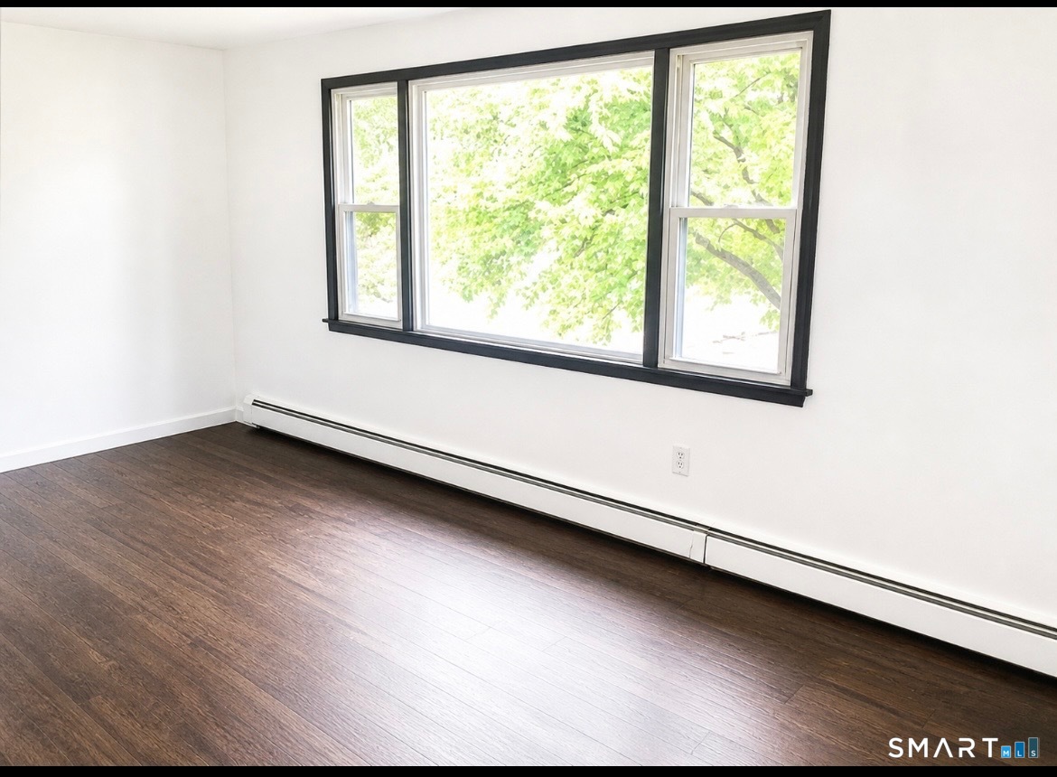 862 Pleasant Valley Road South Windsor, CT 06074 - Photo 6 of 13 a view of a room with wooden floor and a window