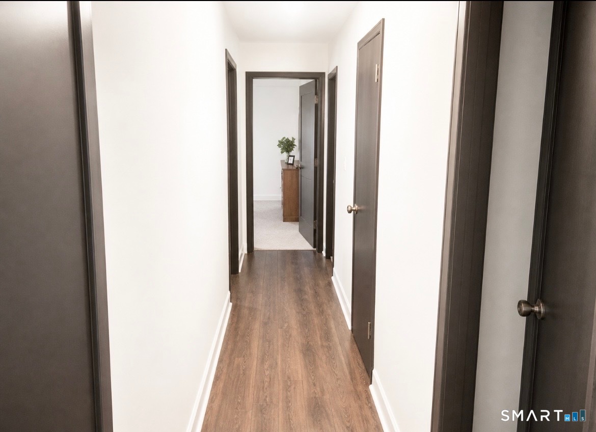 862 Pleasant Valley Road South Windsor, CT 06074 - Photo 8 of 13 a view of a hallway with wooden floor
