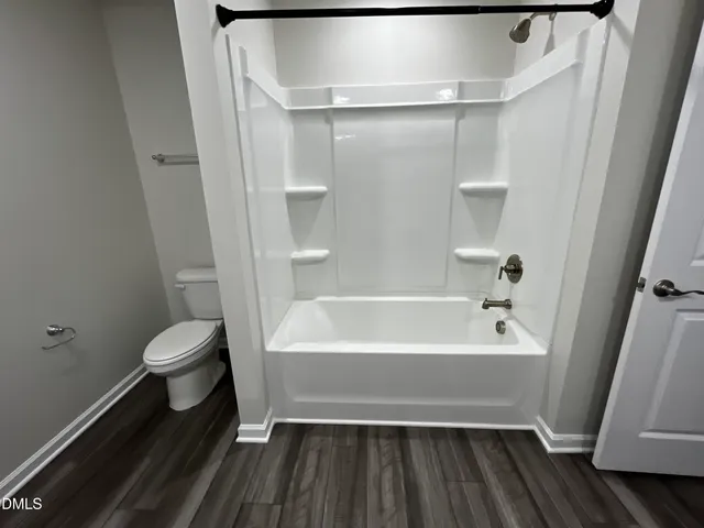 a bathroom with a sink mirror and shower