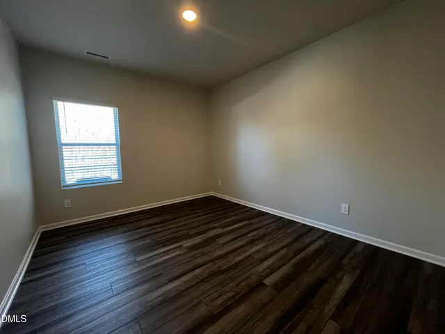 a view of an empty room and wooden floor