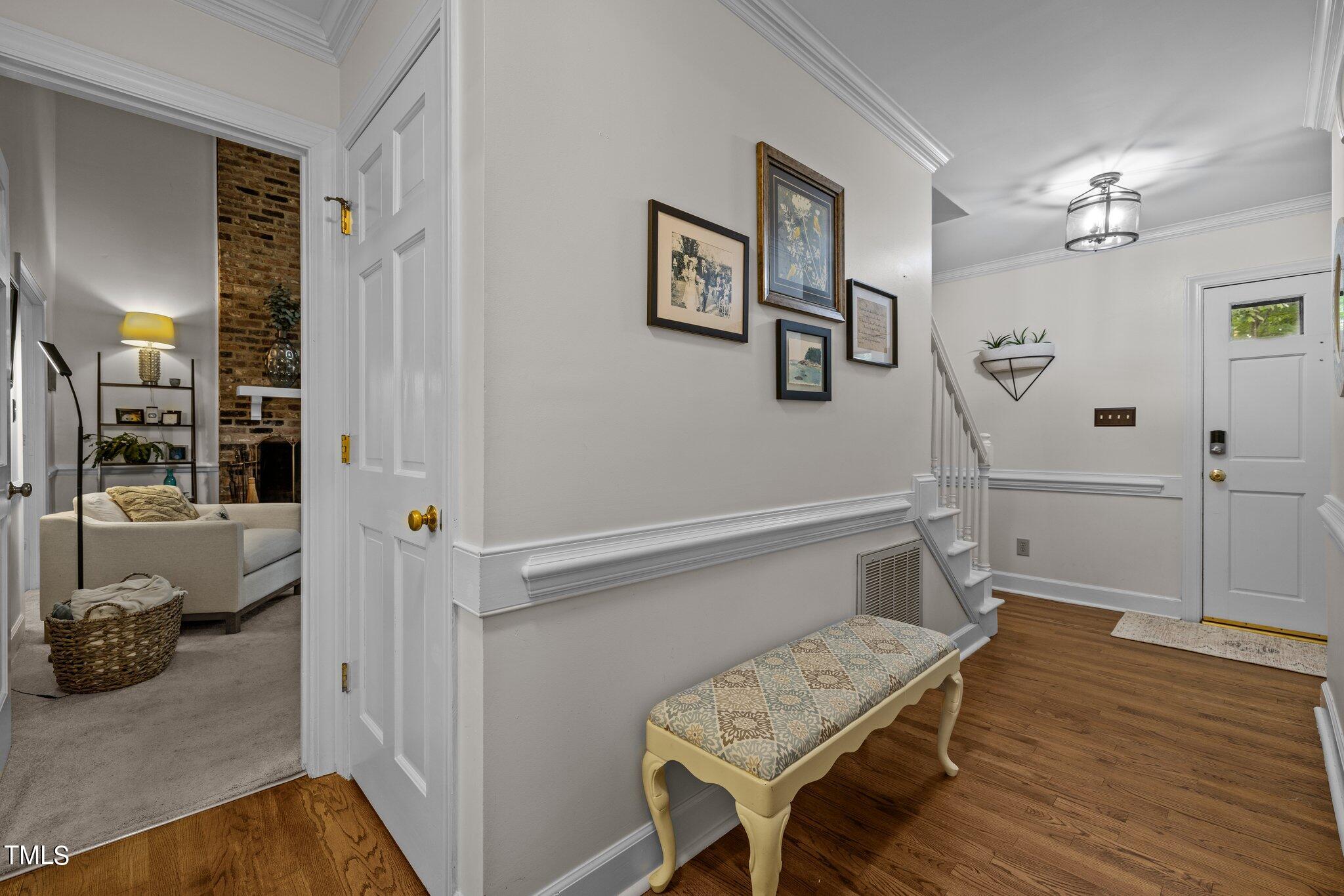 7916 Hilburn Drive Raleigh, NC 27613 - Photo 5 of 24 a view of hallway with wooden floor and furniture