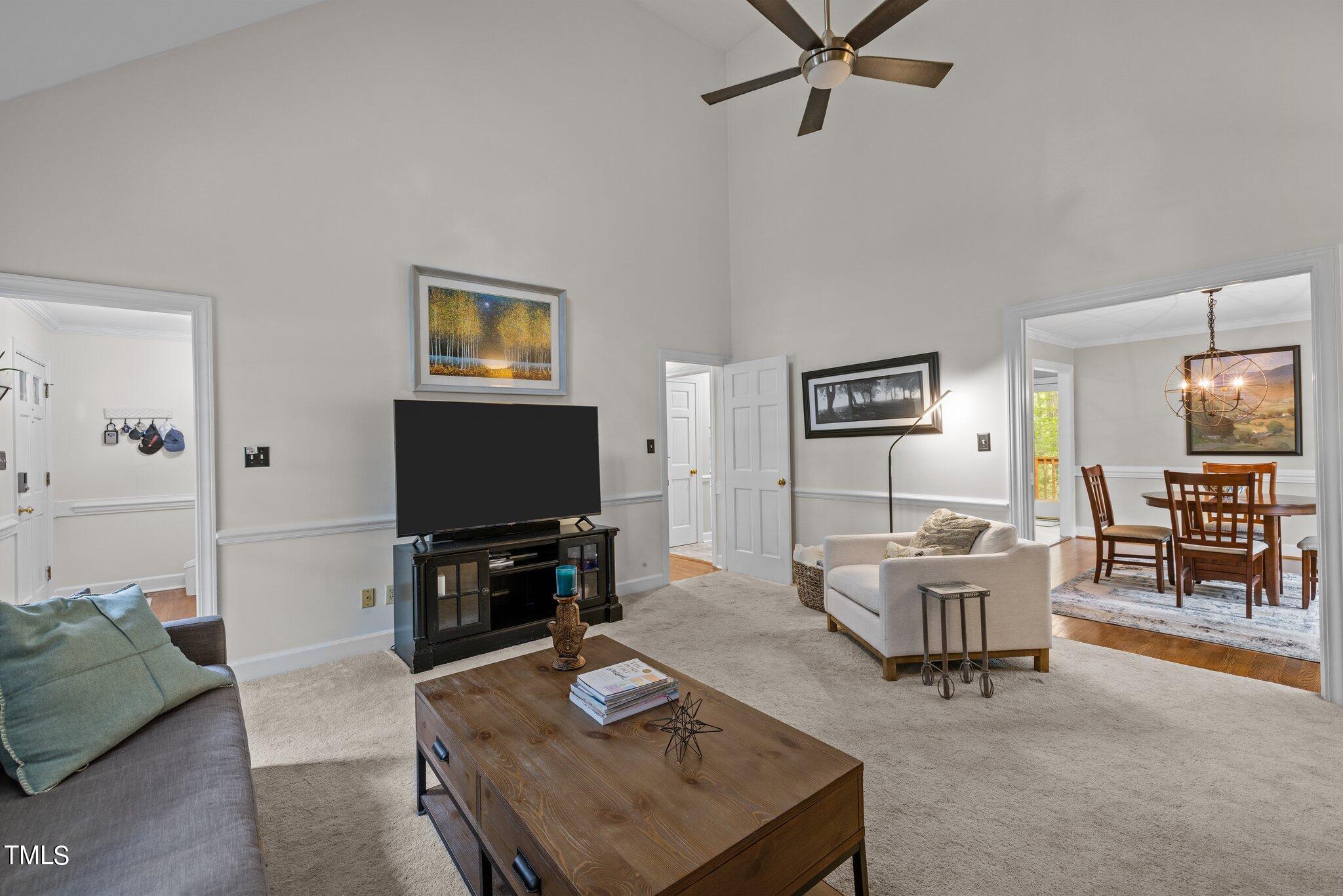 7916 Hilburn Drive Raleigh, NC 27613 - Photo 8 of 24 a living room with furniture and a flat screen tv
