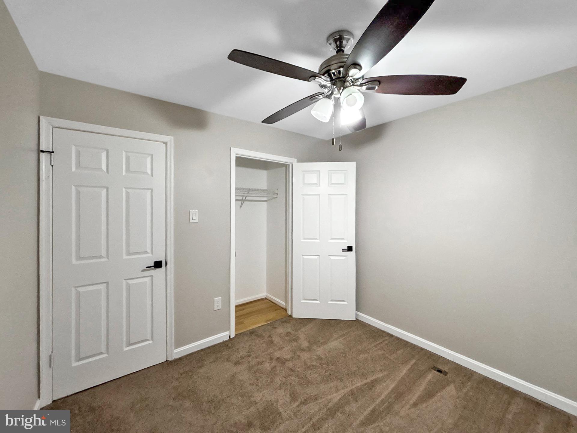 3558 Corn Stream Road Randallstown, MD 21133 - Photo 7 of 27 an empty room with closet and a chandelier fan