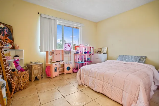 a bedroom with bed and large window