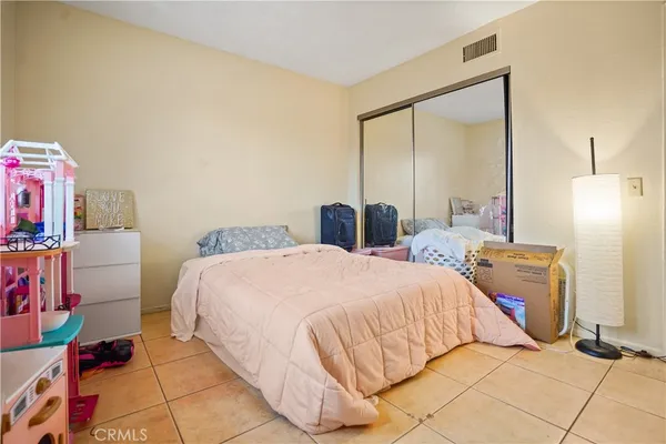 a bedroom with a bed and a mirror