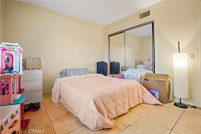 a bedroom with a bed and a mirror