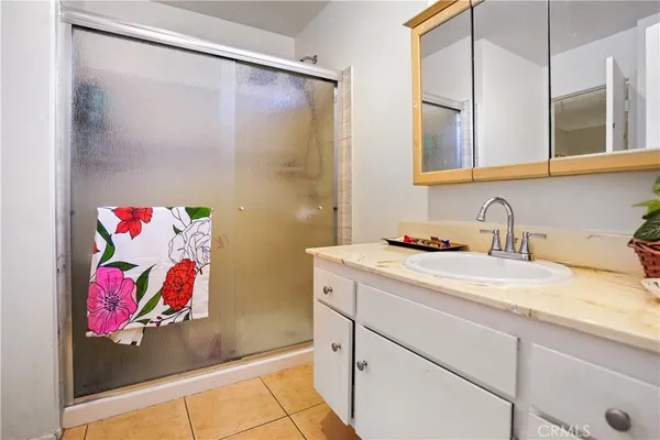 a bathroom with a granite countertop sink mirror and vanity