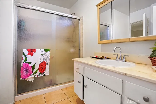 a bathroom with a granite countertop sink mirror and vanity