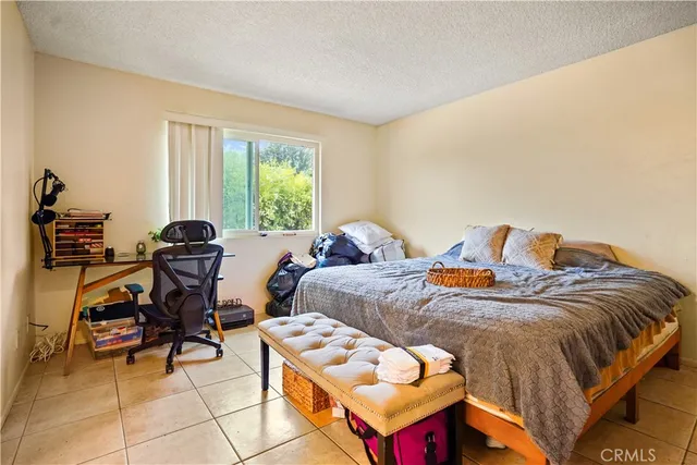 a bed sitting in a room next to a window