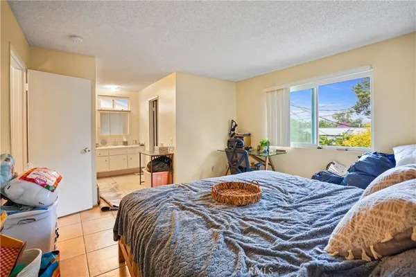 a bed room with a bed and a chair