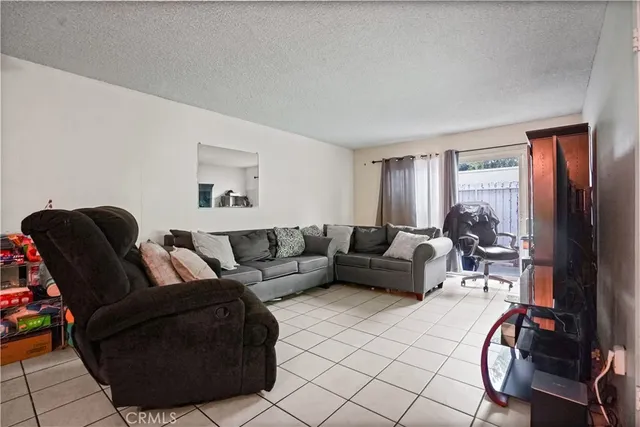 a living room with furniture and a dining table