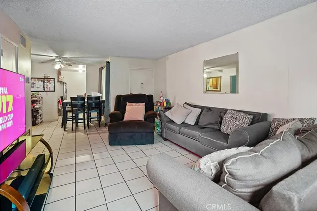 a view of a dining room with furniture and a chandelier fan