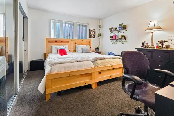 a bedroom with furniture a fireplace and a flat tv screen