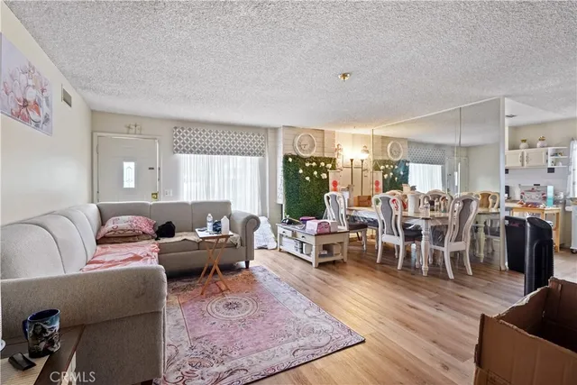 a living room with furniture dining table and a large window